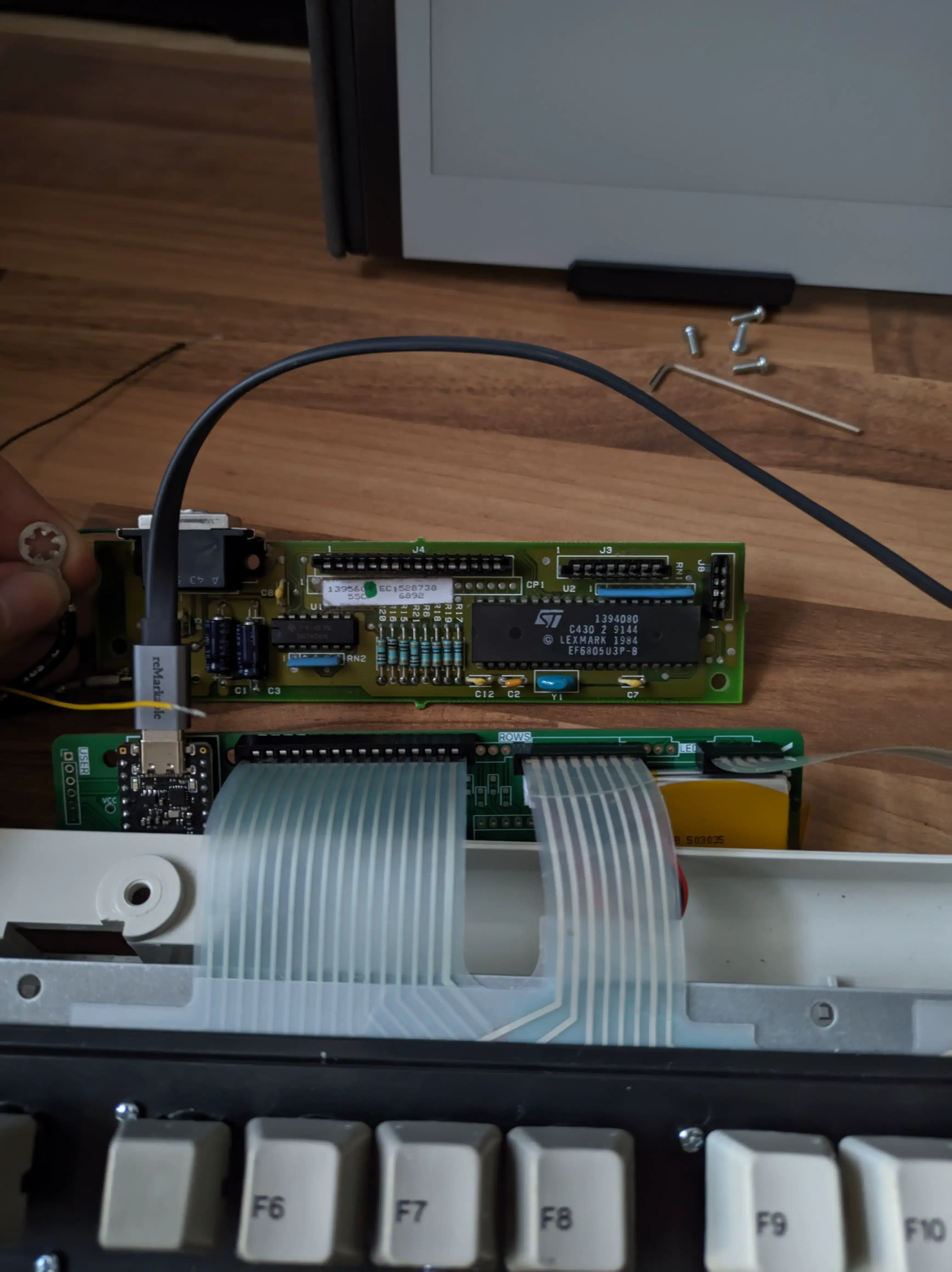 The first working modelk board next to the original controller.