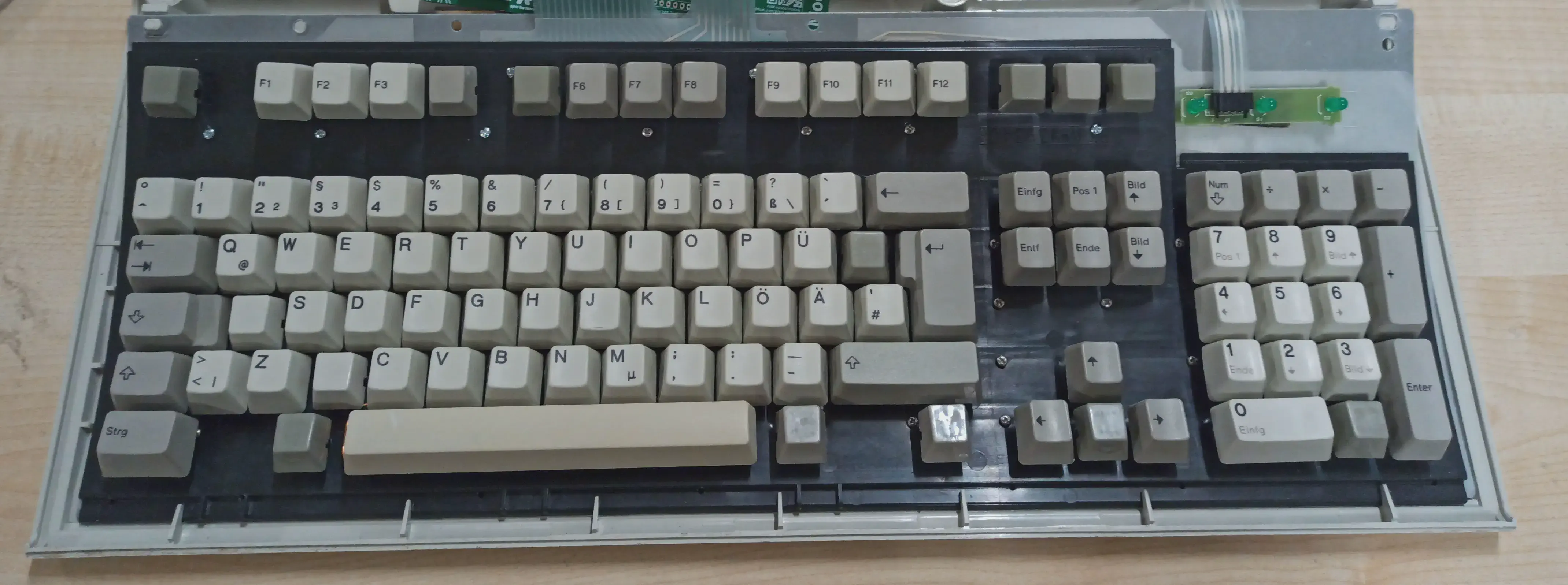 The keyboard after bolt modding. Some screws are visible in the black frontplate.